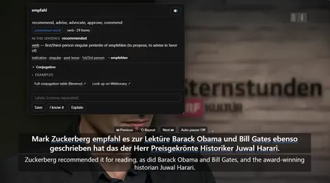 A paused YouTube video with German and English subtitles, and the word card open above it showing the meaning, part of speech and grammar of the clicked word empfahl.